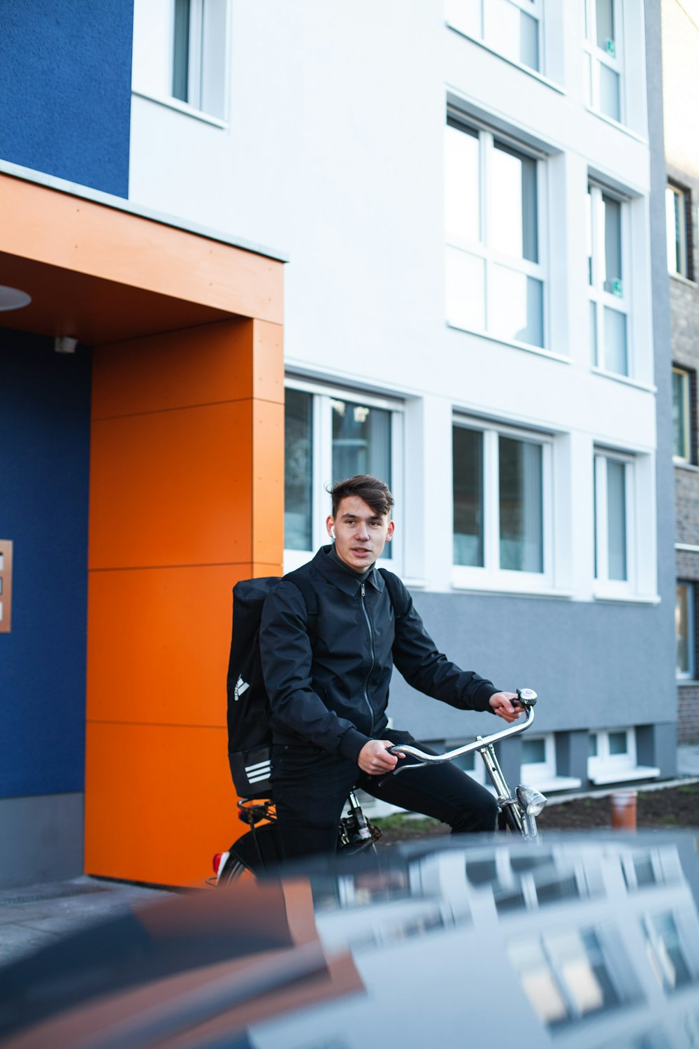 man in black suit riding on black motorcycle during daytime