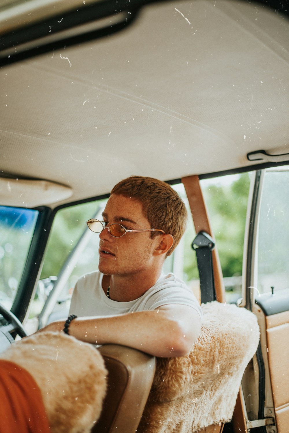 man in white crew neck t-shirt wearing black framed eyeglasses