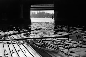 Historic black and white image of the 1928 Olympic rowing event, matching the stamp theme.