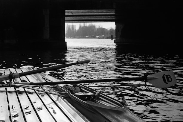 Historic black and white image of the 1928 Olympic rowing event, matching the stamp theme.