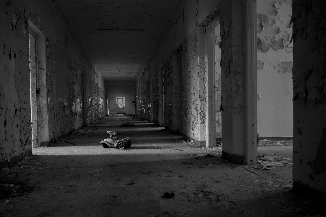 grayscale photo of car parked in tunnel