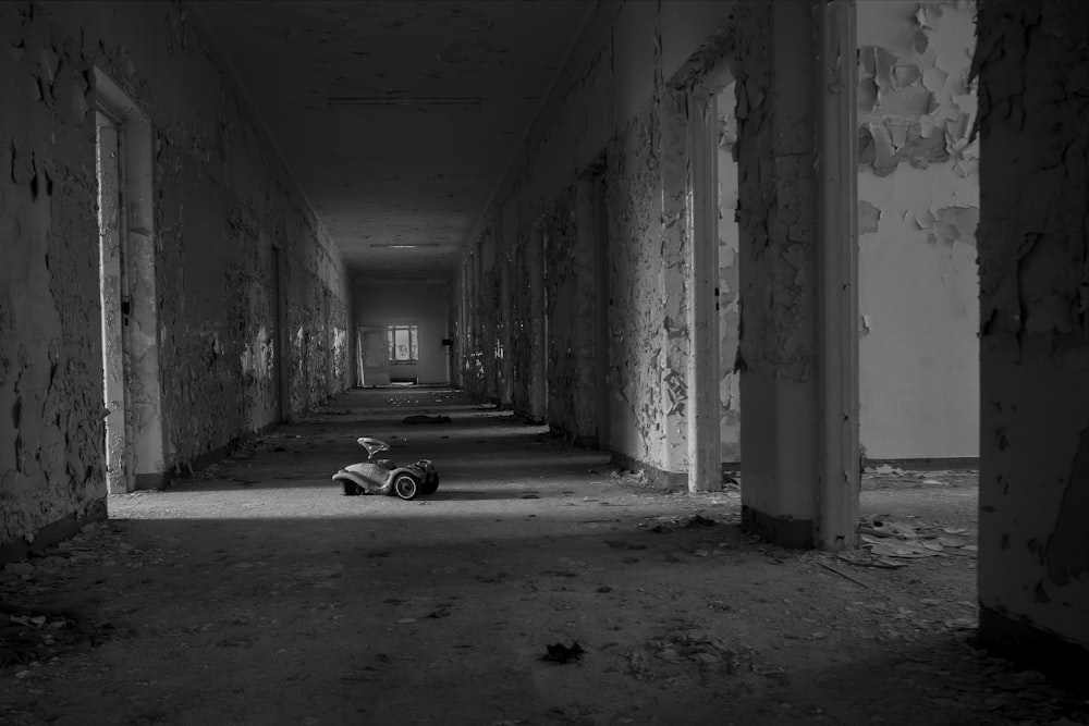 grayscale photo of car parked in tunnel