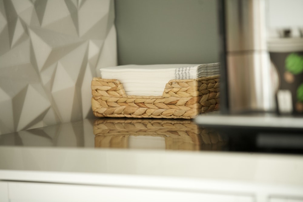 brown woven basket on white table