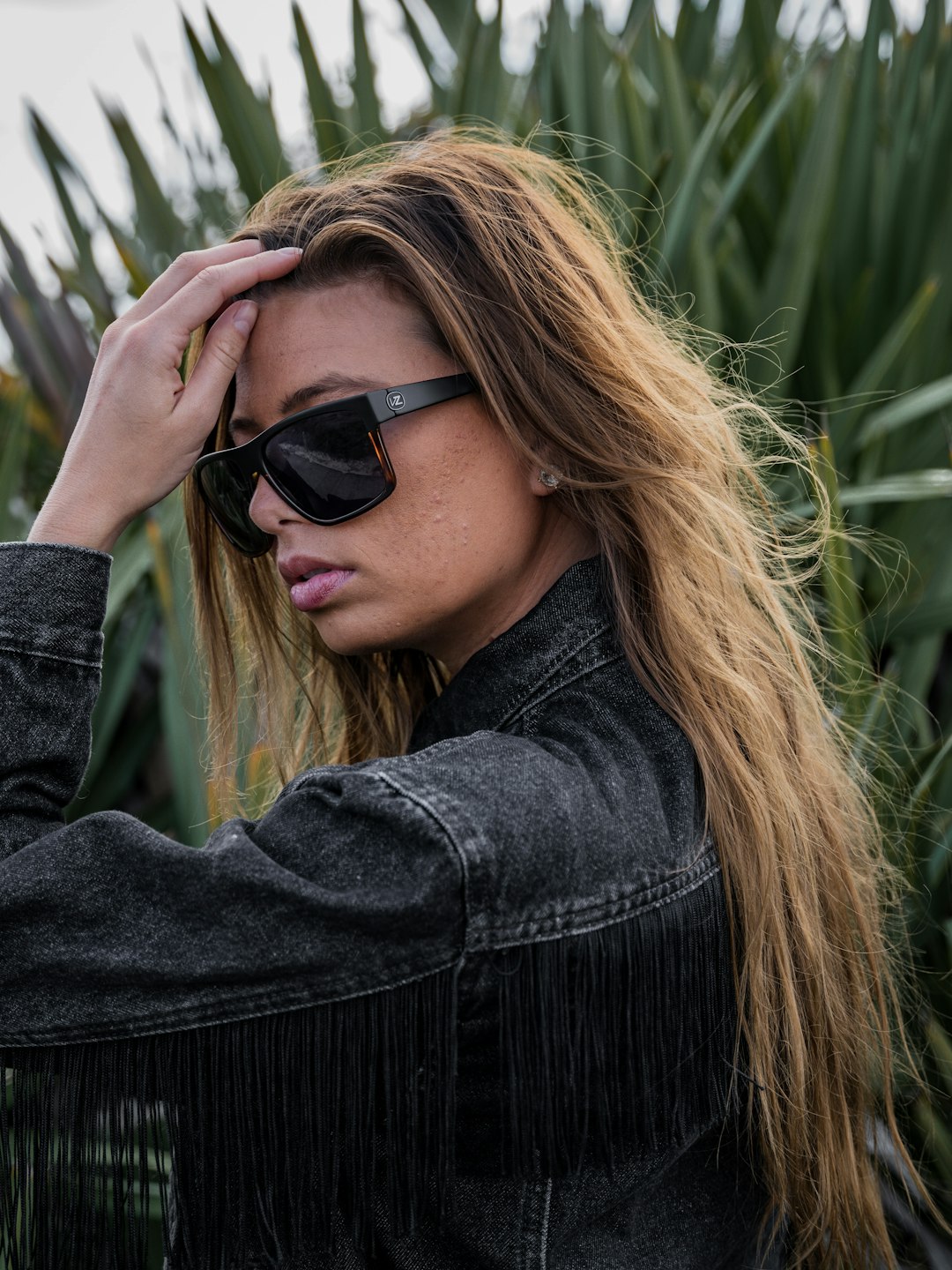 woman in black jacket wearing black sunglasses
