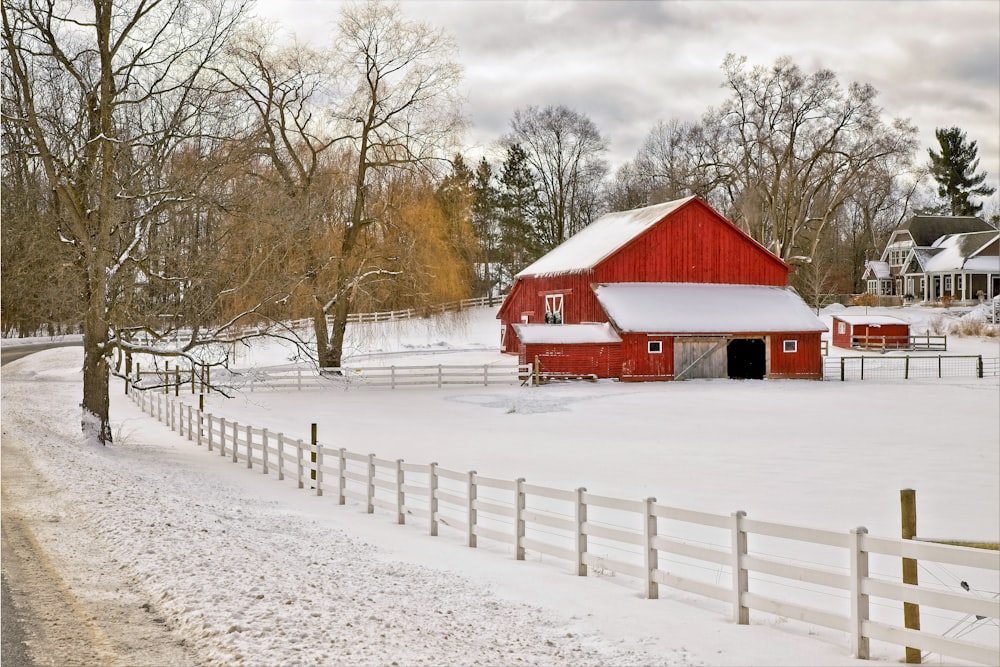 red and white wooden house on snow covered ground