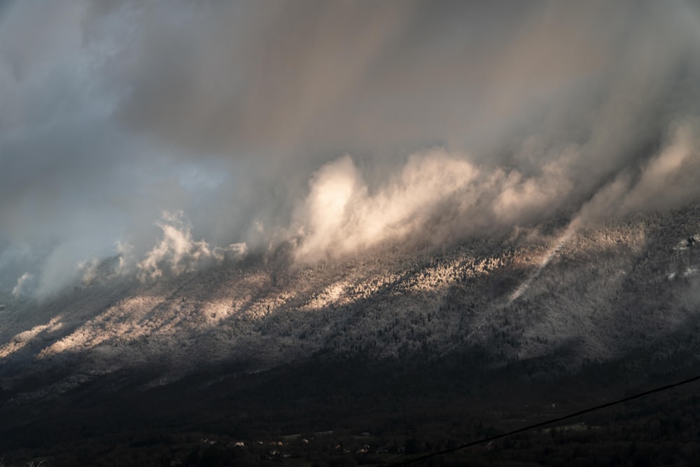 white clouds over black mountain