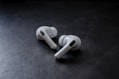 white earbuds on black textile