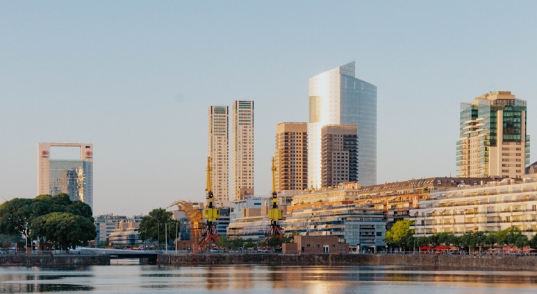 white and brown concrete building near body of water during daytime
