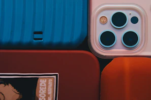 A close-up shot of colorful mobile skins wrapped around various smartphones, highlighting textures and patterns.