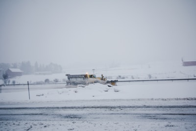A snow plow clearing a road during winter.