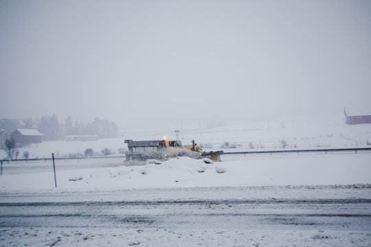 A snow plow clearing a driveway in winter.