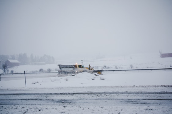 A snow-covered driveway being cleared by a professional snow removal service in Langley.