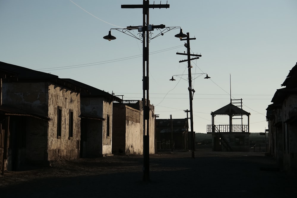 brown and white concrete building near black electric post under blue sky during daytime