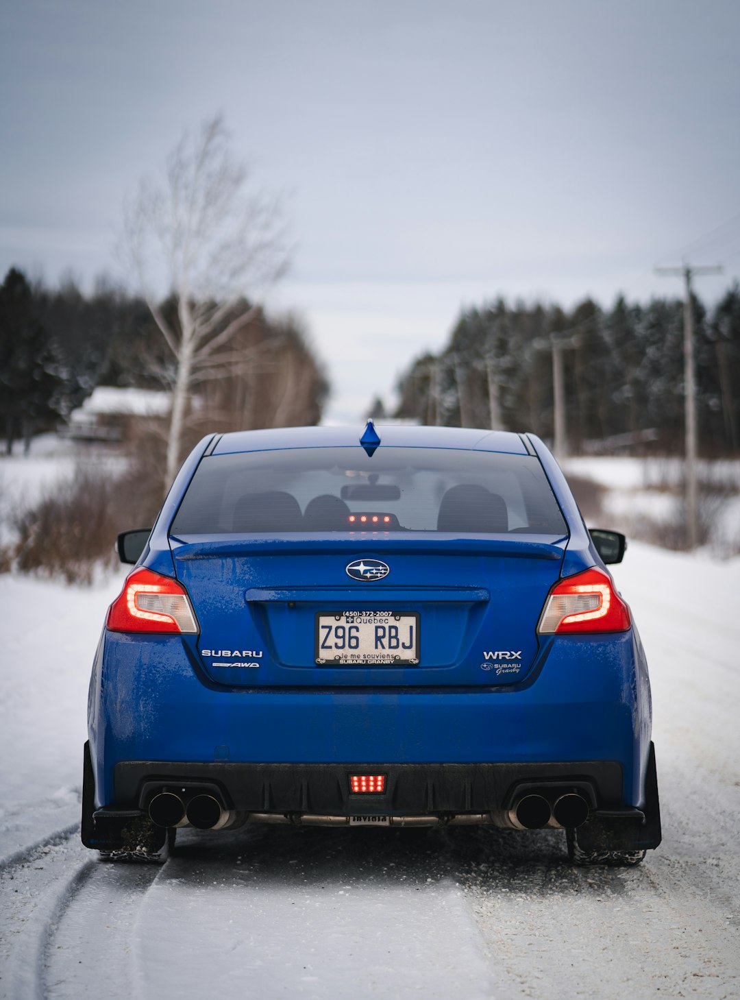 blue honda car on snow covered road during daytime