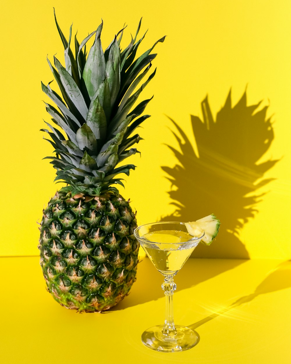 pineapple beside clear wine glass