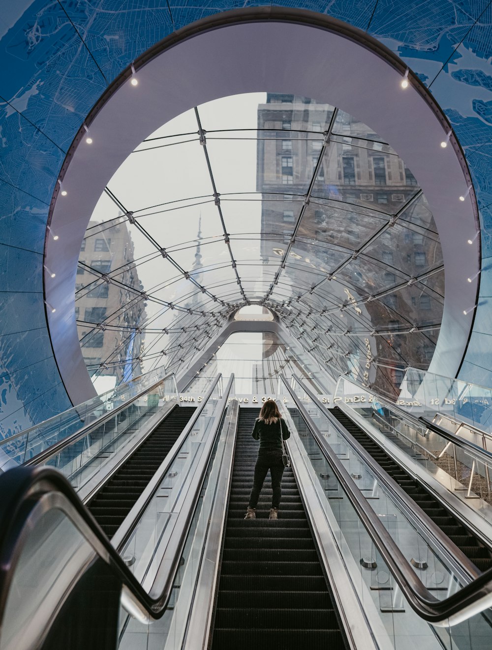 people walking on escalator inside building