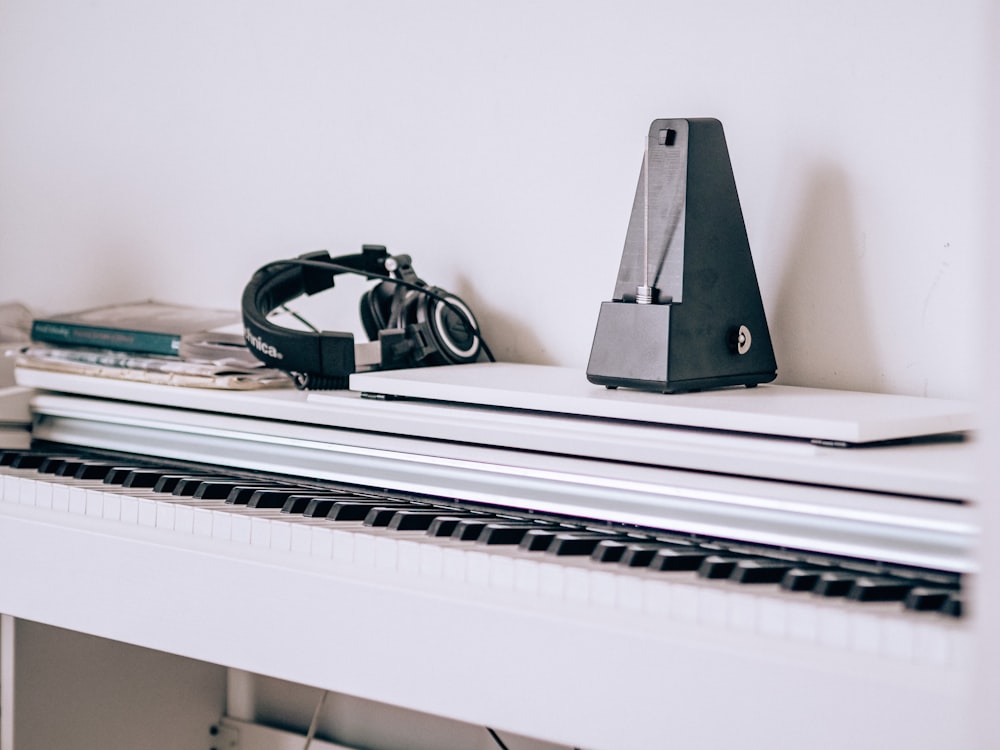 black and green headphones on black and white piano