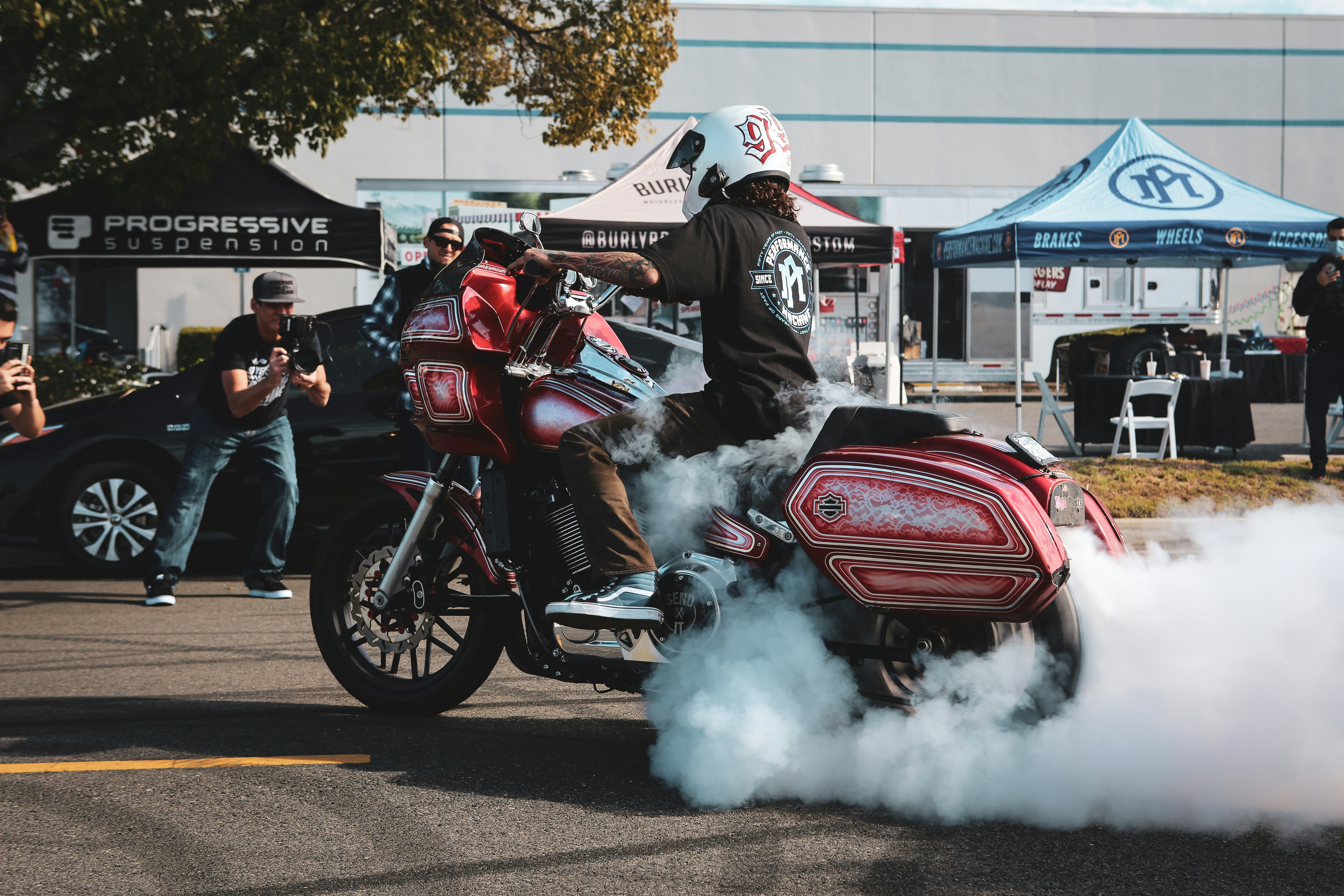 people riding on red and black sports bike during daytime