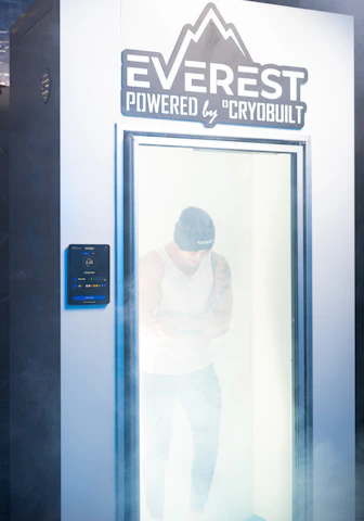 Athletes preparing inside a modern hyperbaric chamber with premium seating and ambient lighting.