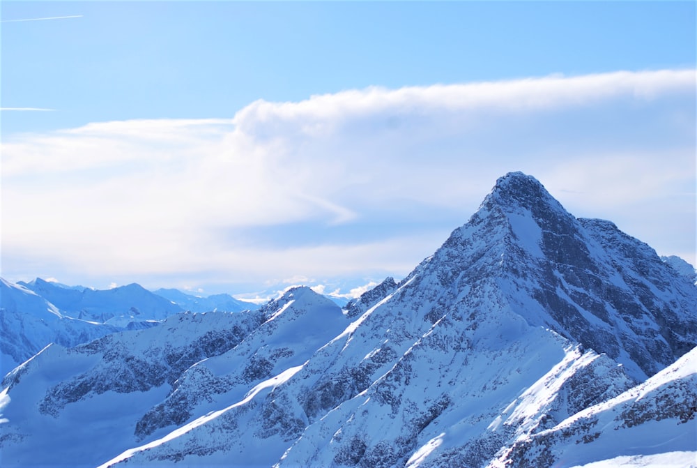 snow covered mountain under cloudy sky during daytime