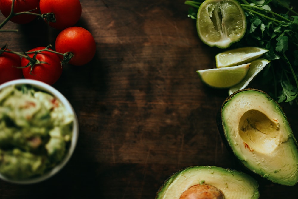 sliced green cucumber and red tomato on brown wooden table