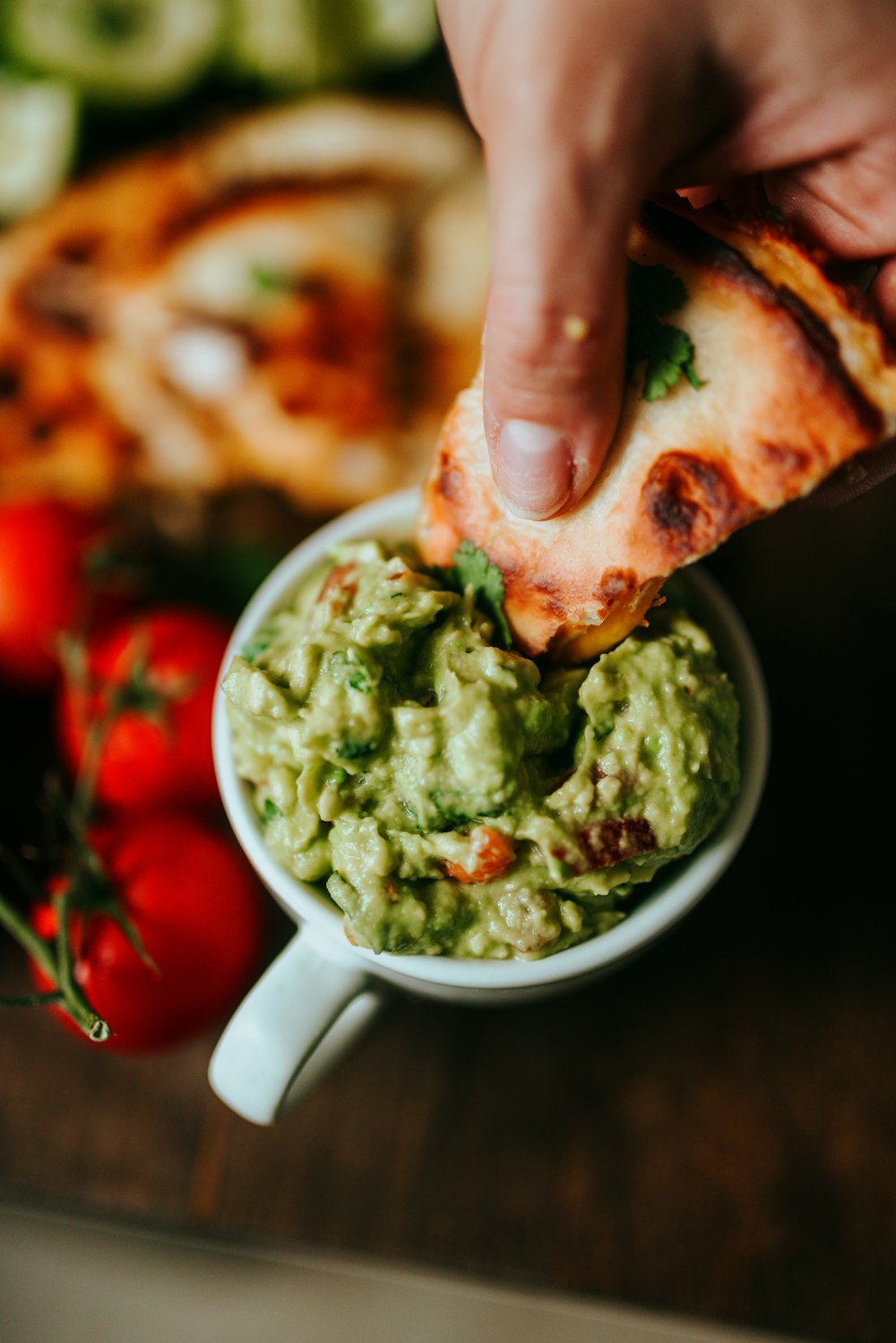 person holding green and brown food