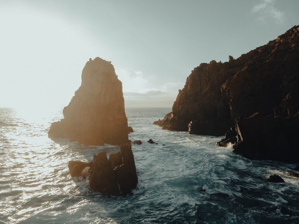 brown rock formation on sea during daytime