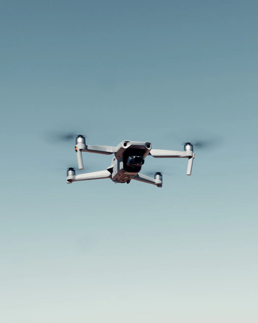 A drone hovering over a construction site capturing aerial images for structural analysis.