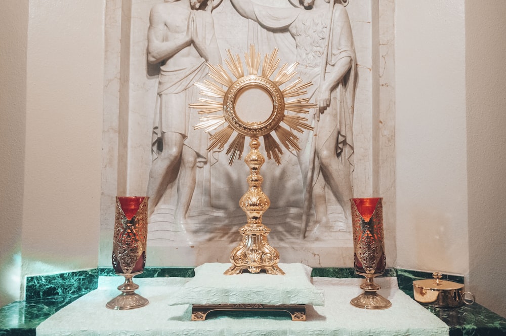 gold and red cross on white table