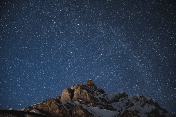 brown rocky mountain under blue sky during night time