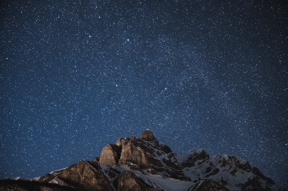 brown rocky mountain under blue sky during night time