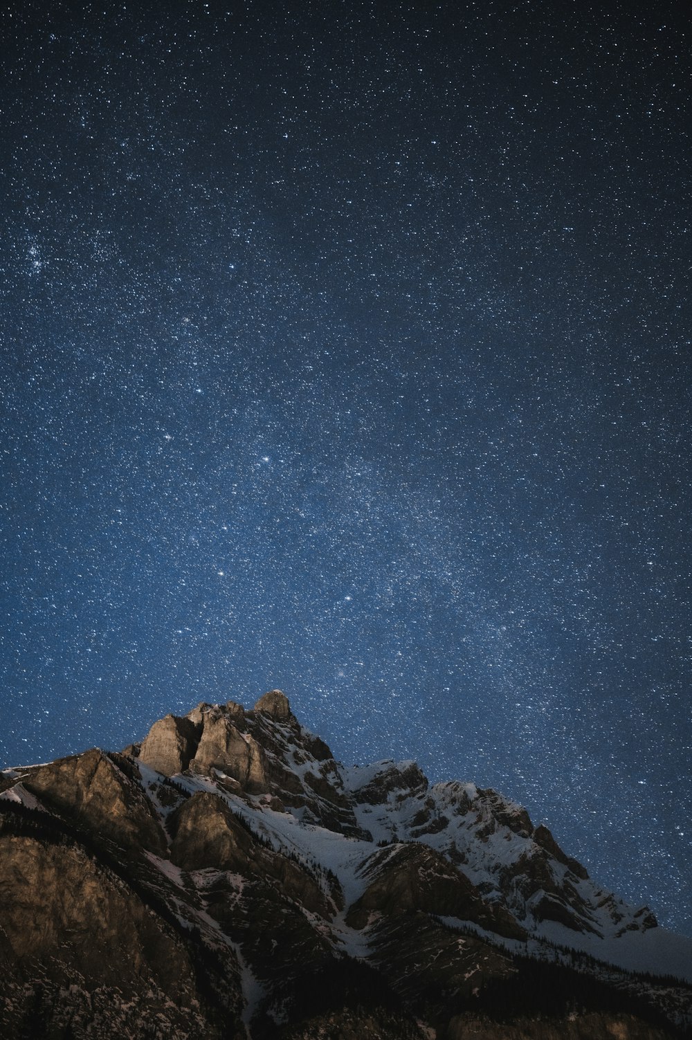 brown rocky mountain under blue sky during night time