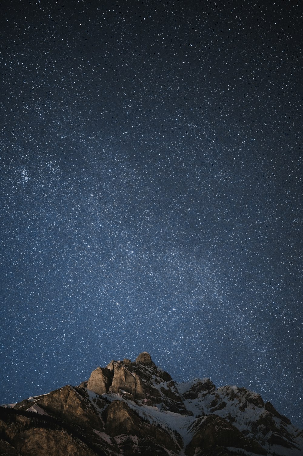 brown rock formation under blue sky during night time