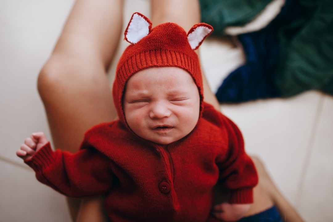 baby in red knit cap