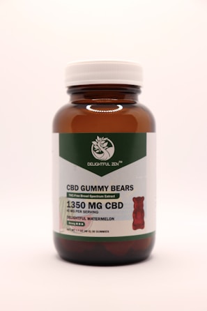 A brown glass bottle with a white cap contains CBD gummy bears. The label indicates THC-free broad-spectrum extract with 1350 mg of CBD. The flavor is delightful watermelon, and there are 30 gummies per bottle.