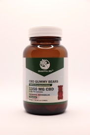 A brown glass bottle with a white cap contains CBD gummy bears. The label indicates THC-free broad-spectrum extract with 1350 mg of CBD. The flavor is delightful watermelon, and there are 30 gummies per bottle.
