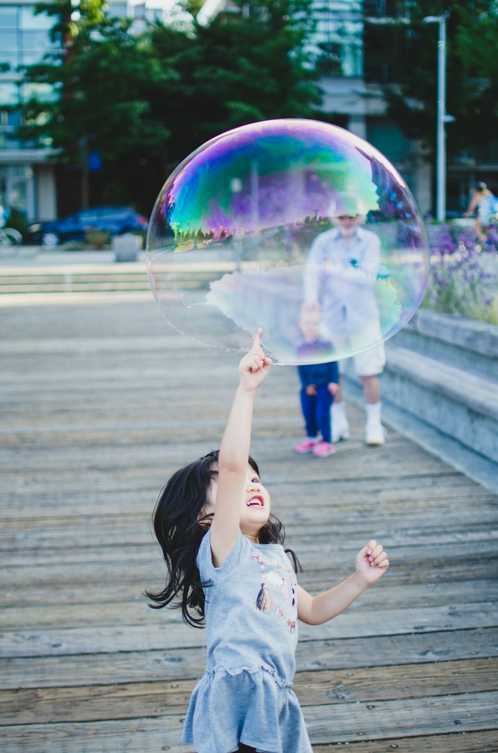 girl in white shirt playing bubbles