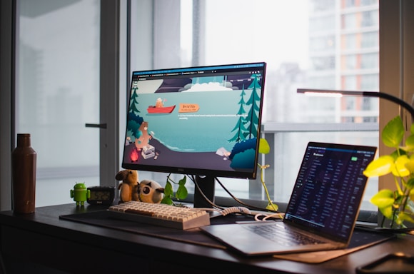 A cozy workspace with a smartphone displaying a colorful app interface, surrounded by fish-themed decor.