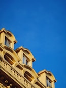 brown concrete building under blue sky during daytime