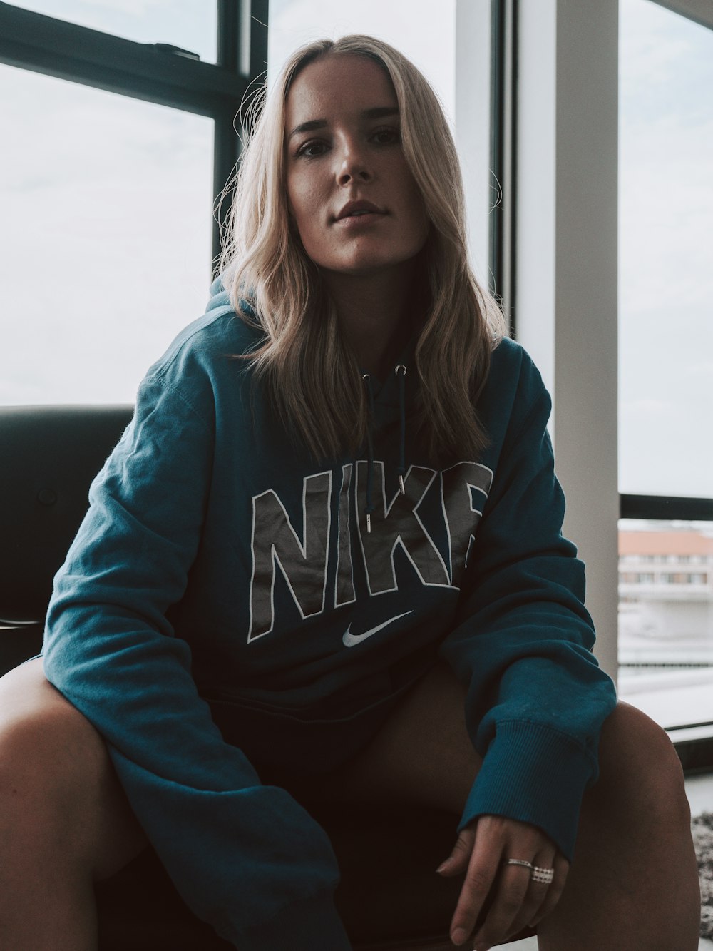 woman in purple hoodie sitting on black chair