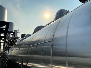 Industrial site with large-scale aluminum architectural systems installed under bright daylight