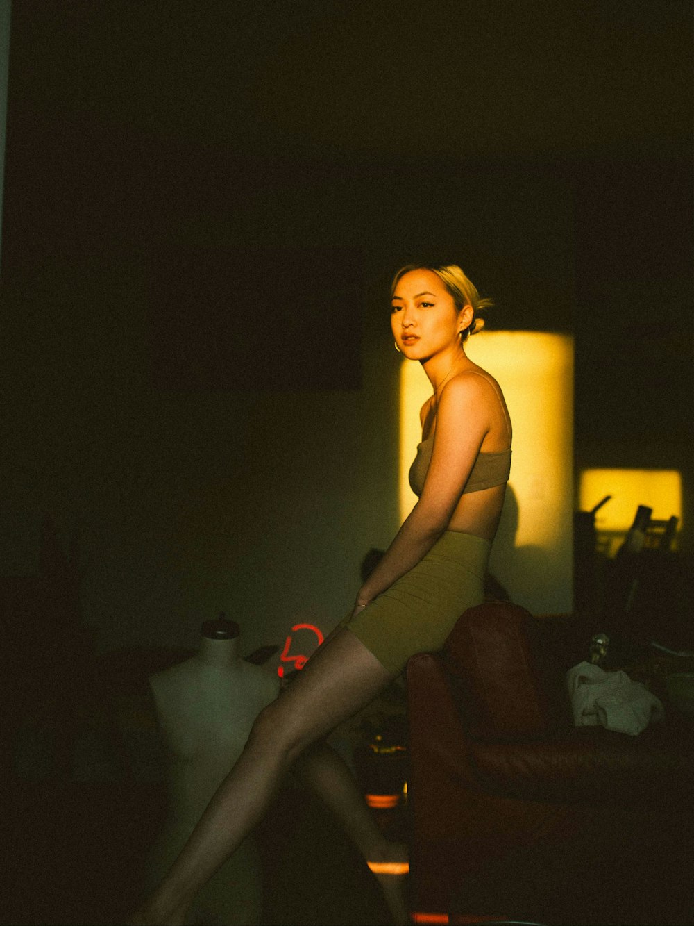 woman in black tank top and gray pants sitting on black couch