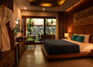 black and white bed near brown wooden table