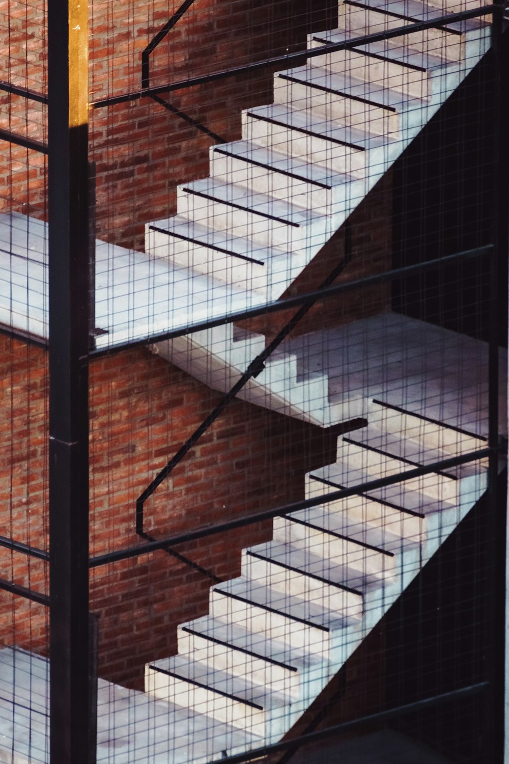 black metal frame on brown concrete staircase