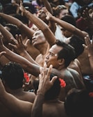 woman in black tank top raising her hands