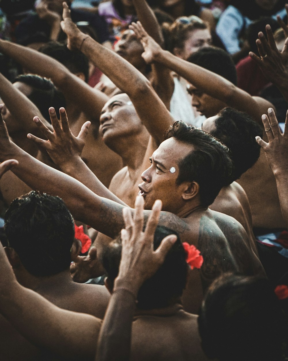 woman in black tank top raising her hands