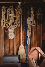 Worker inspecting nautical ropes in a bright workshop with blue accents.