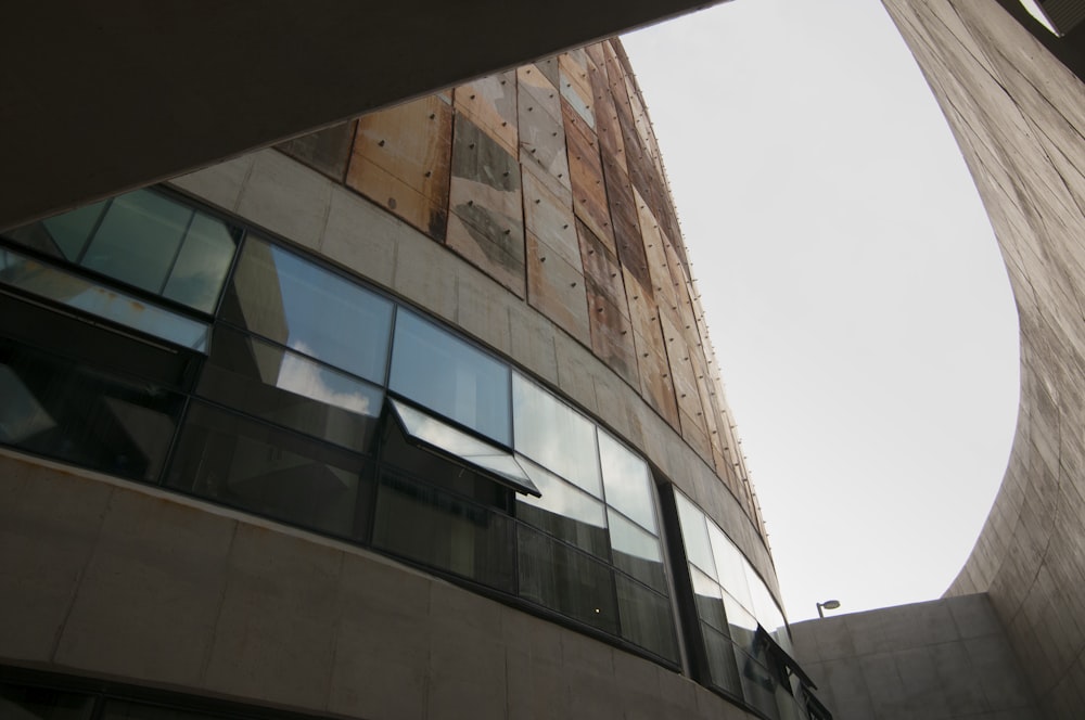 brown and white concrete building under white clouds during daytime