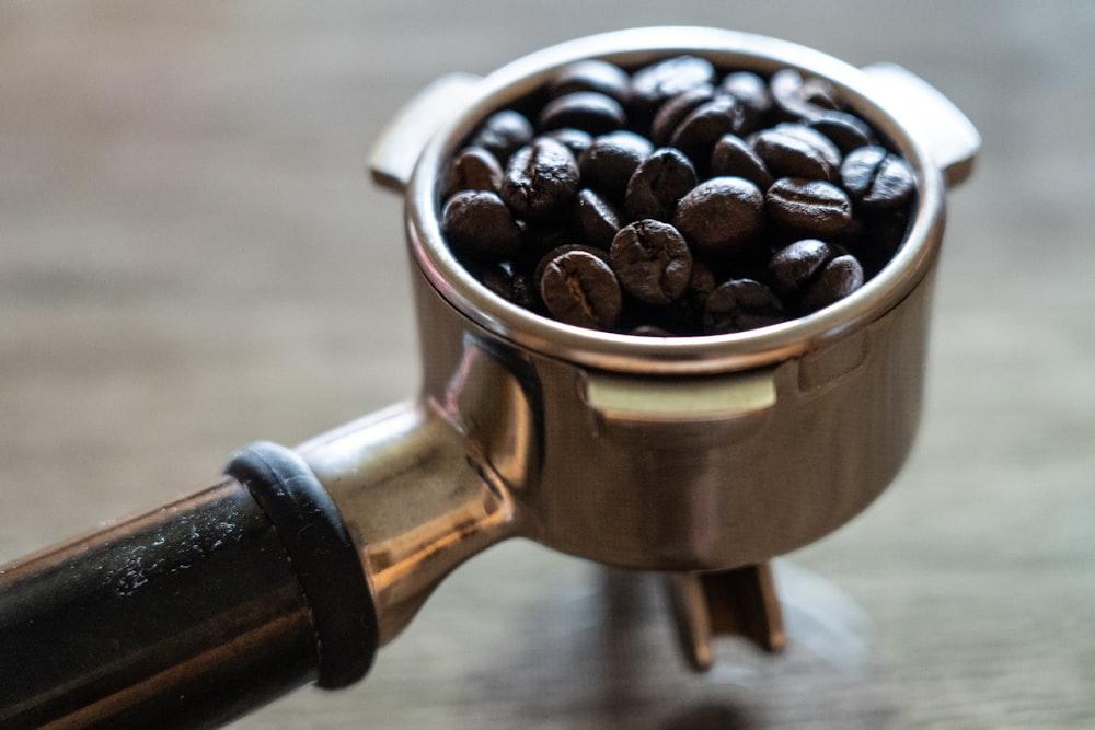 coffee beans in stainless steel cup