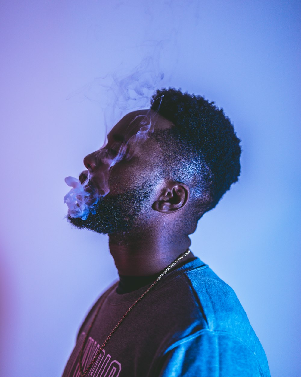 man in blue and black collared shirt